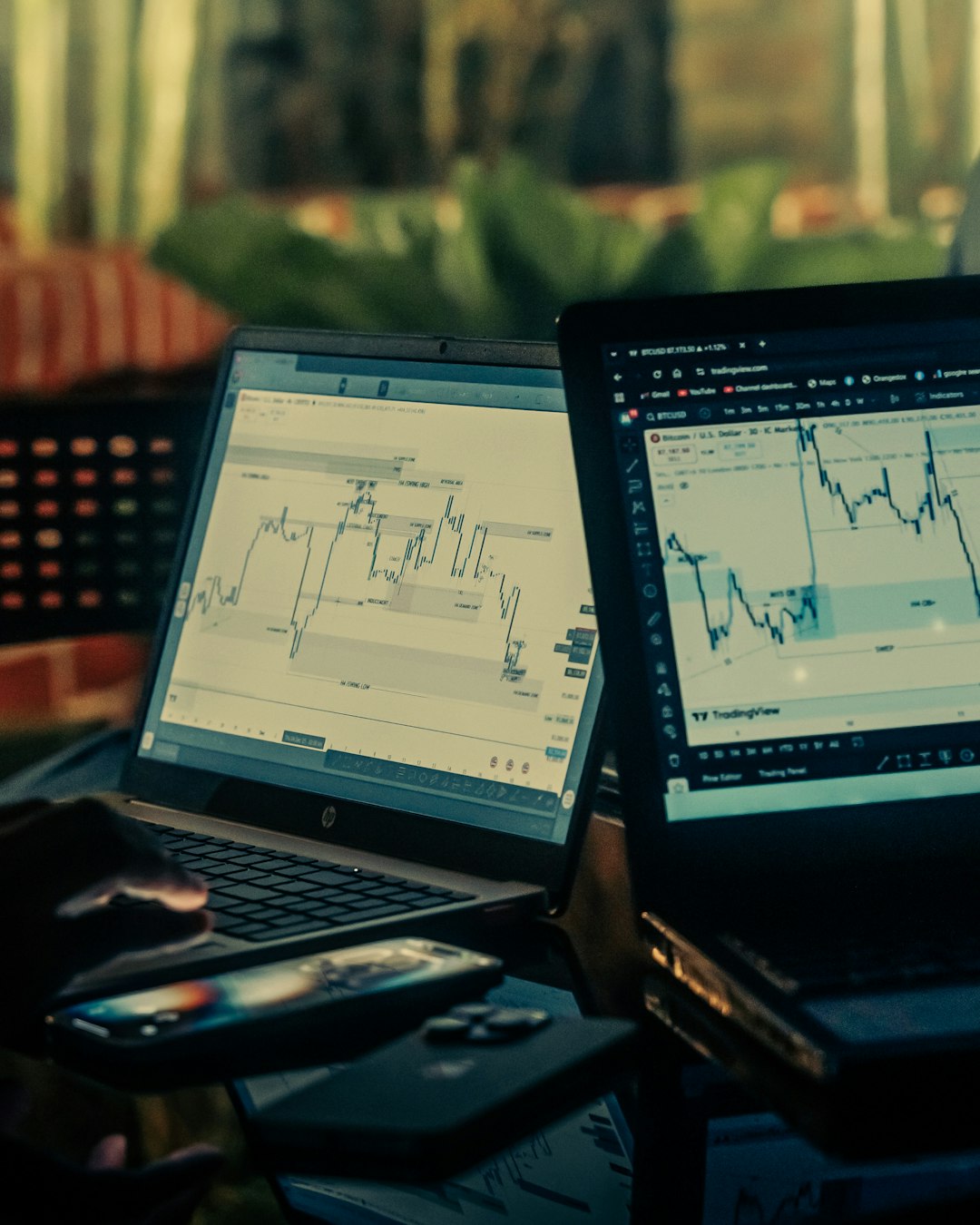about-01 two-laptops-displaying-stock-market-charts-8bm5eh5w7fe